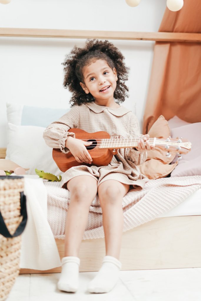 little girl playing ukulele | Ukulele lessons for Kids